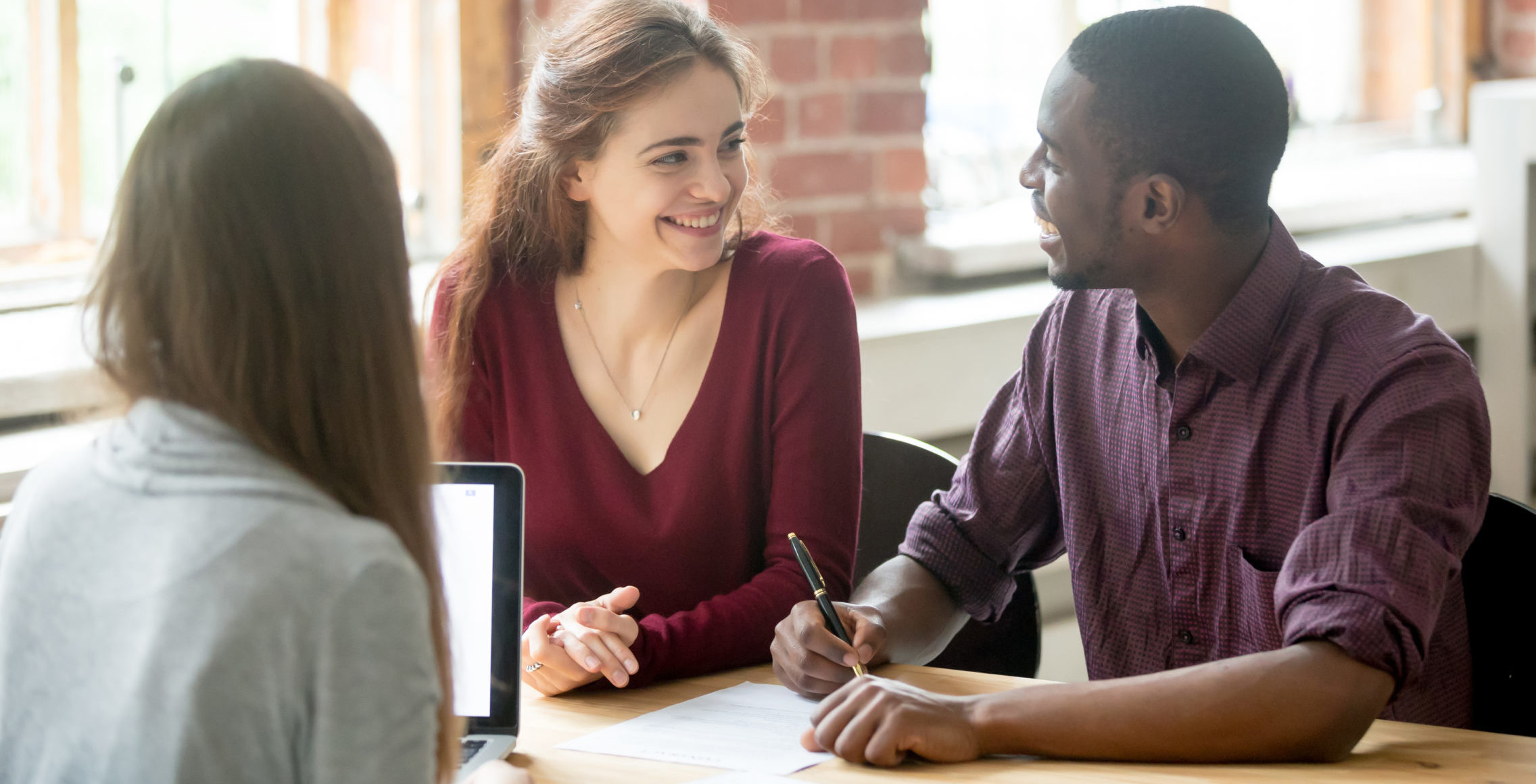 two women and a man sitting