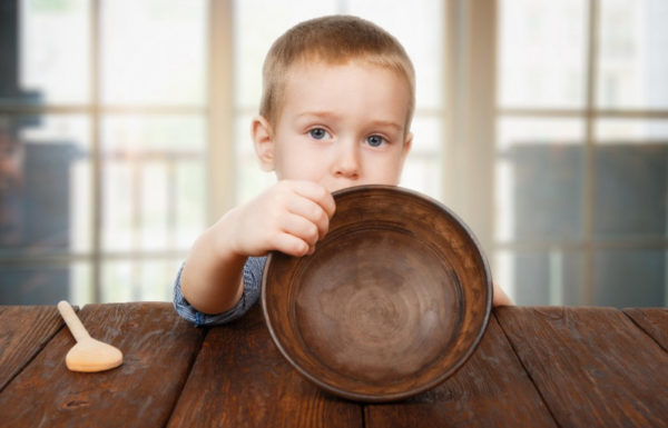 young boy with empty bowl