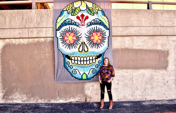 woman in front of quilt