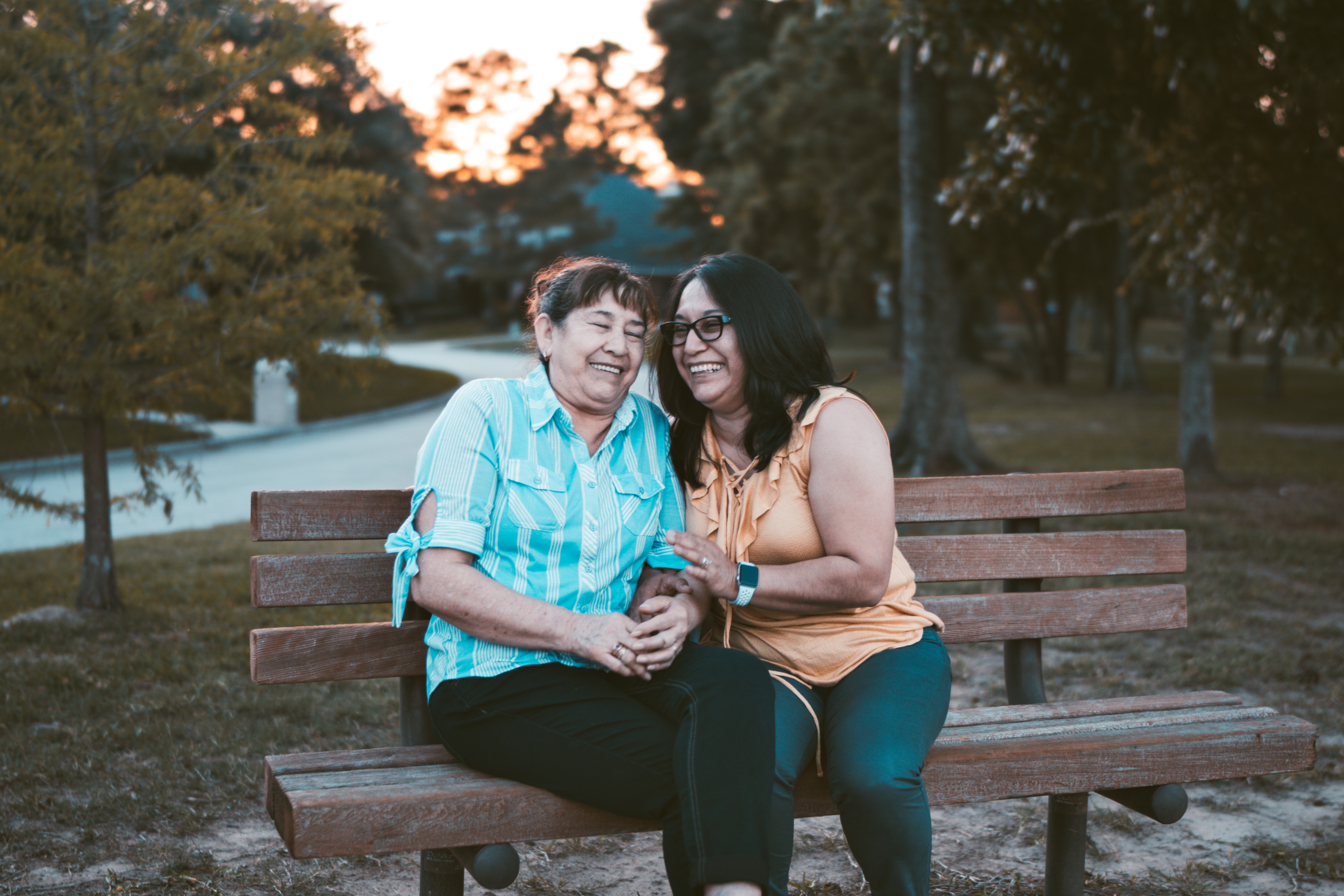 mom and daughter sitting on bench