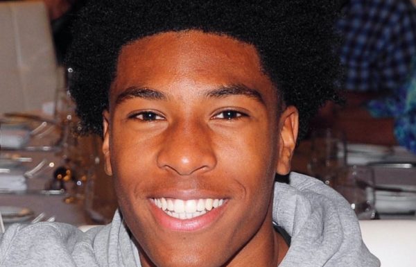 a close-up photo of a smiling teenage boy