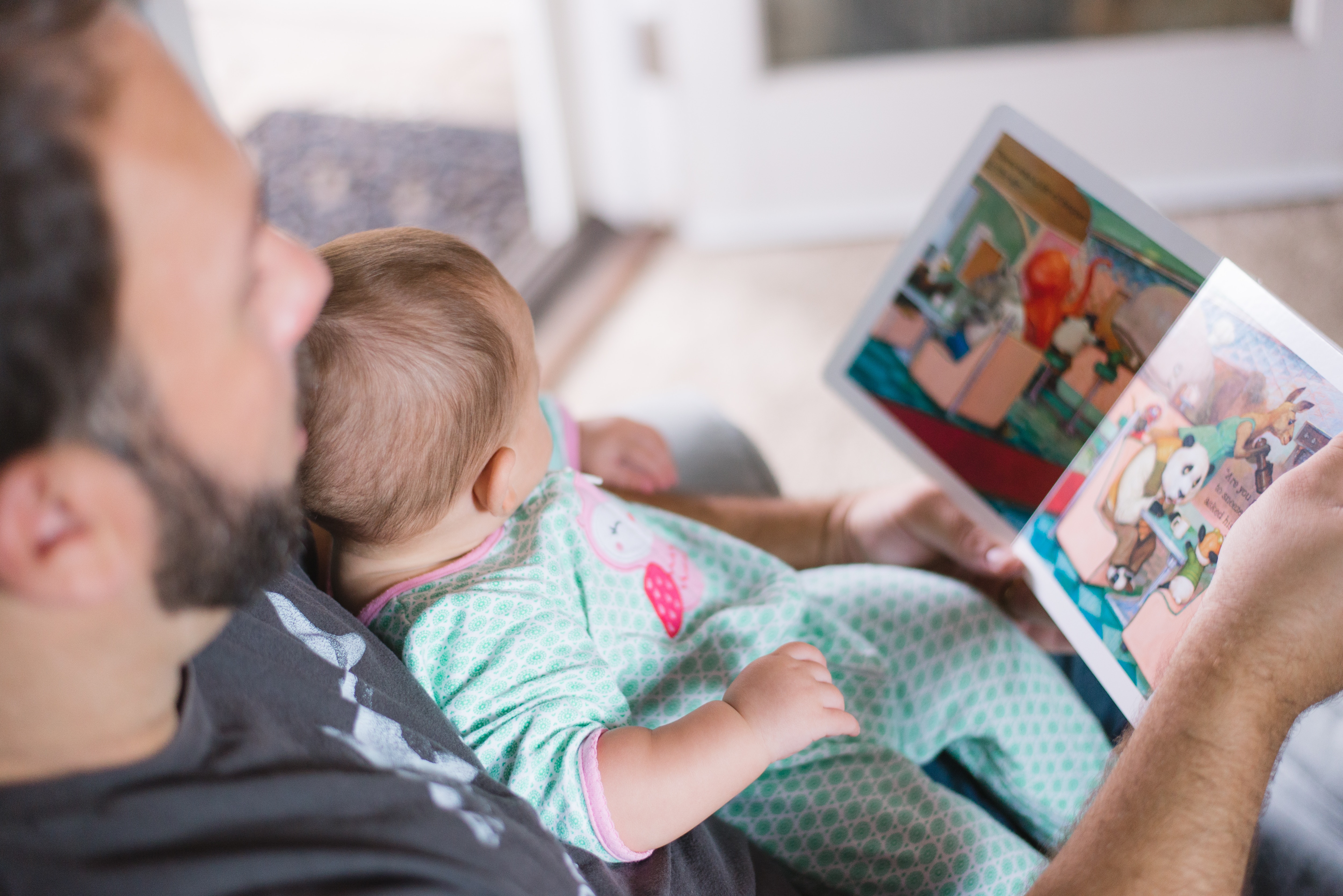 father reading to baby