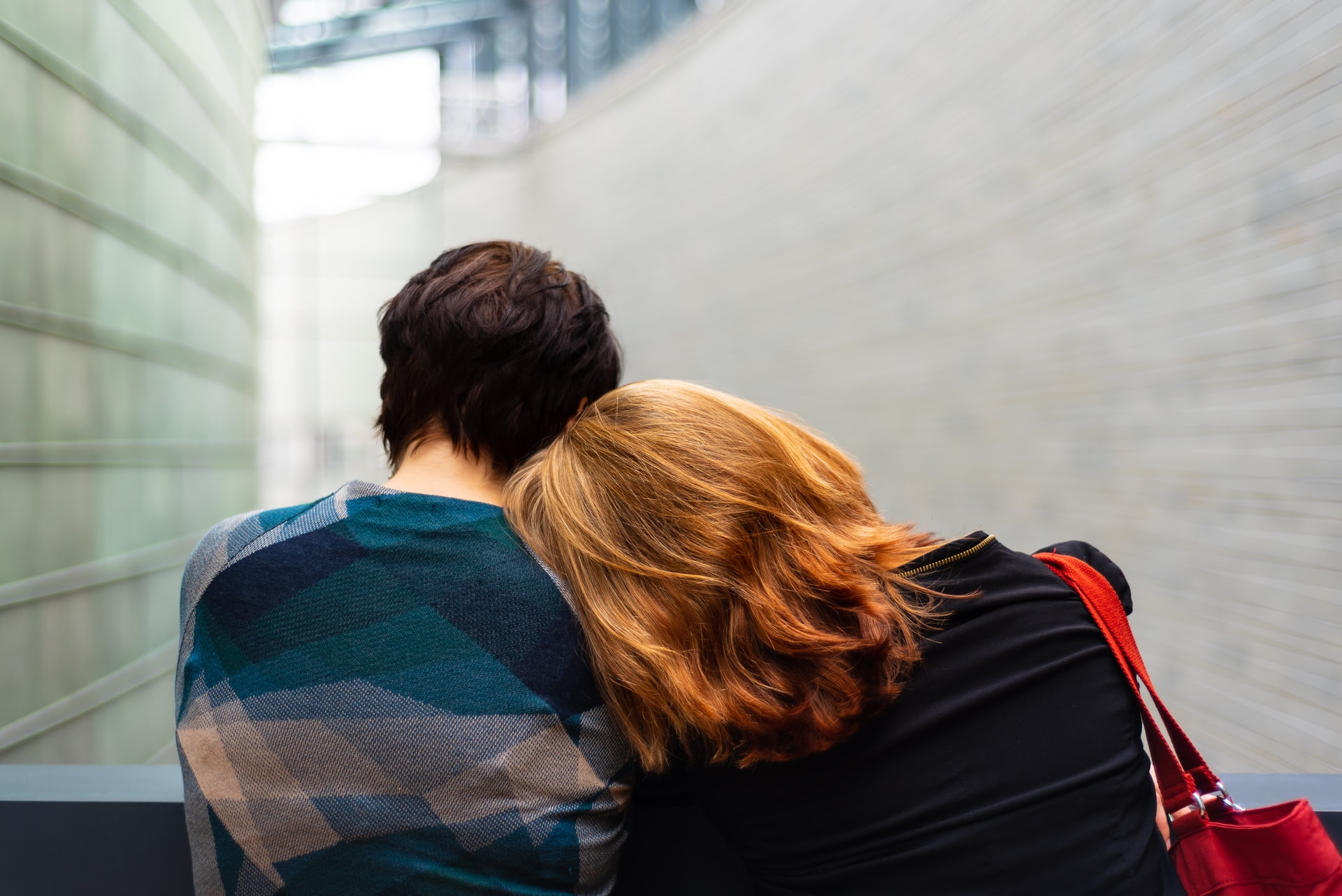 woman with her head laying on man's shoulder