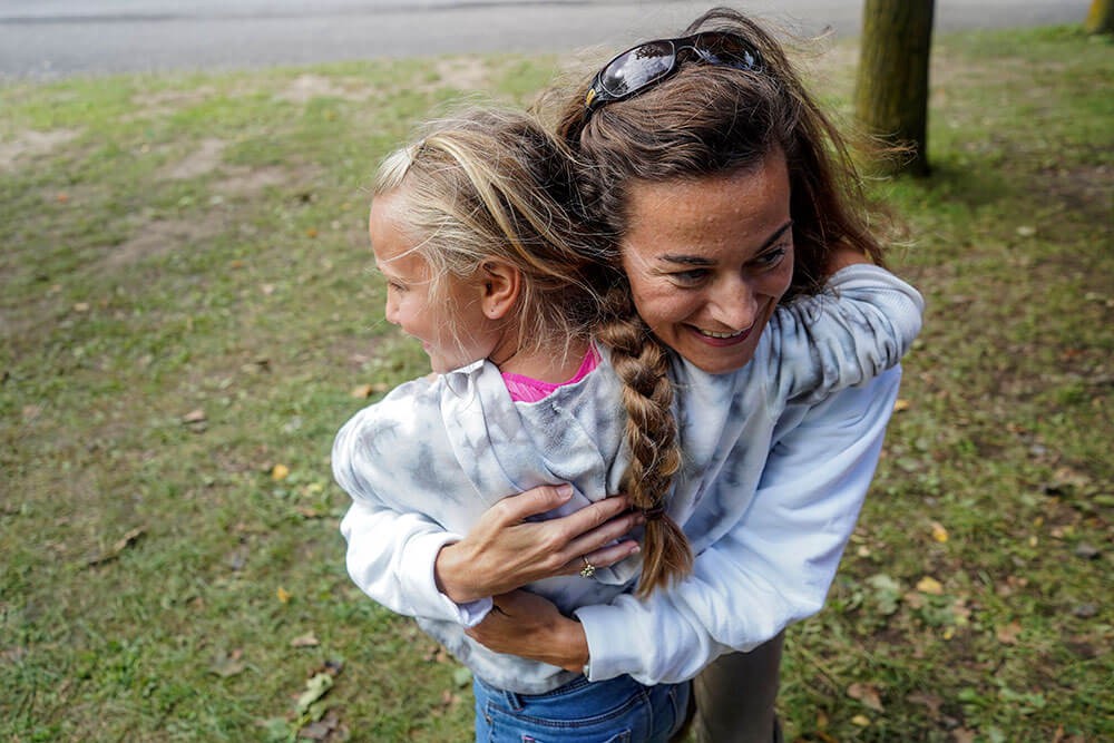 a young girl hugging her mom