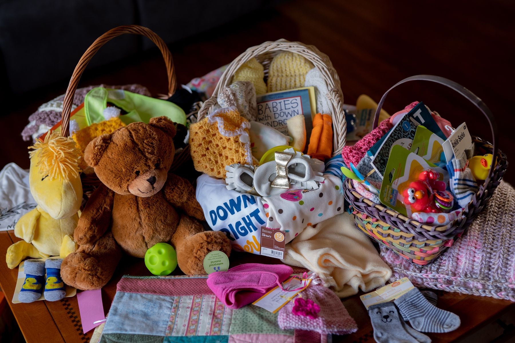 Three baskets filled with toys and baby supplies