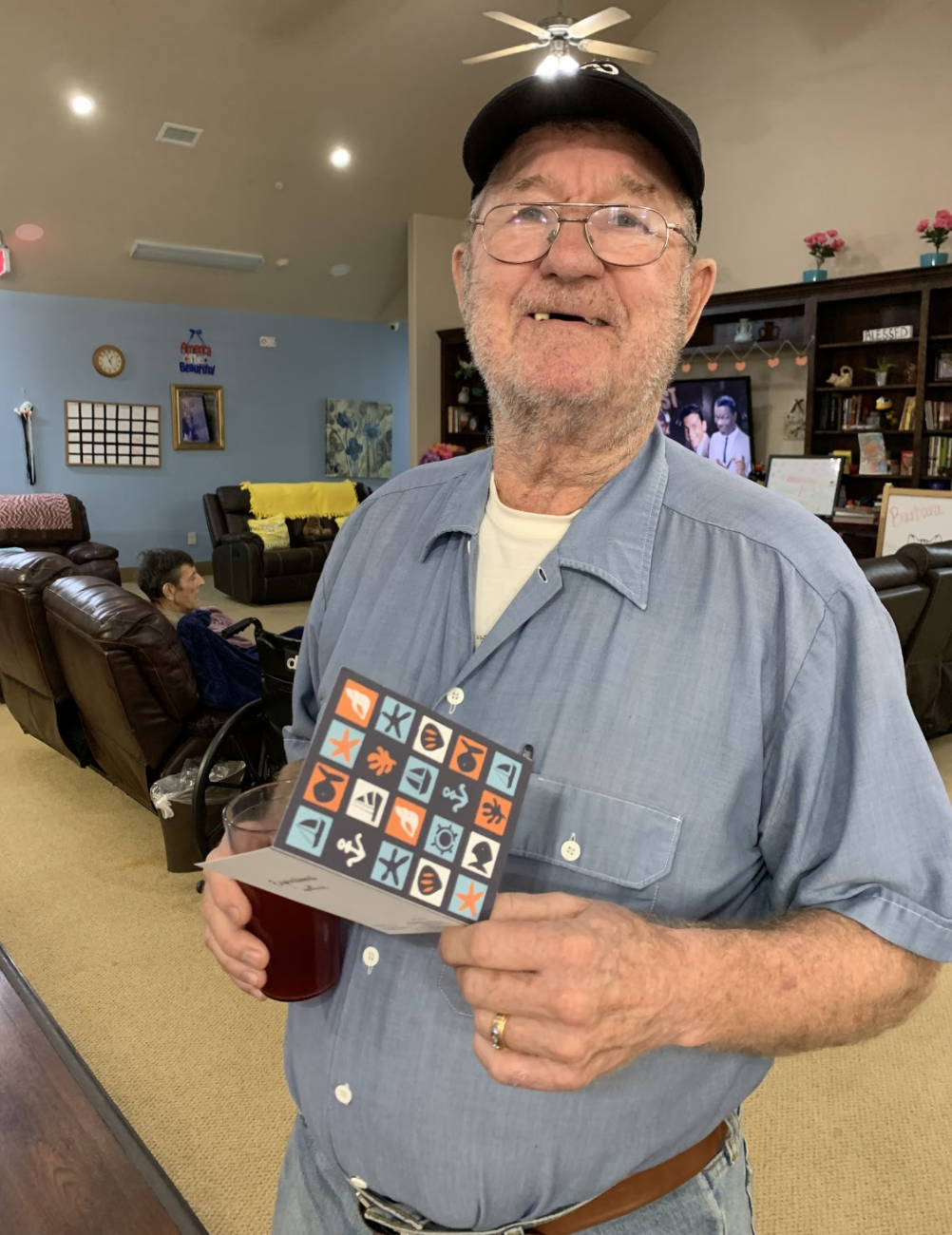 Elderly man reading a card