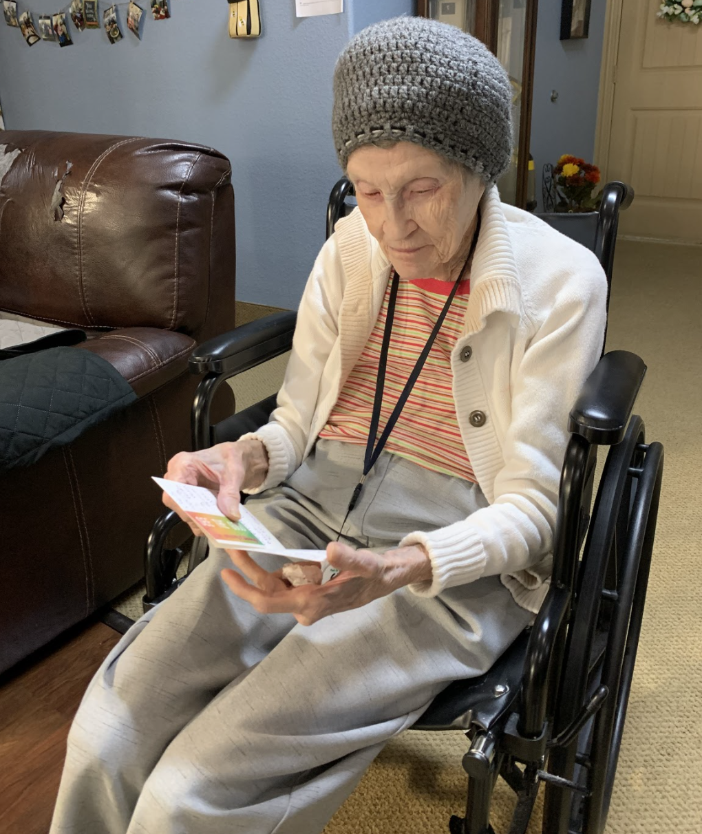 Elderly woman reading a card