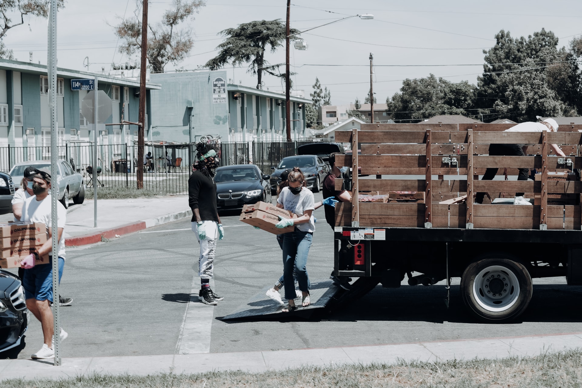 person carrying boxes from truck