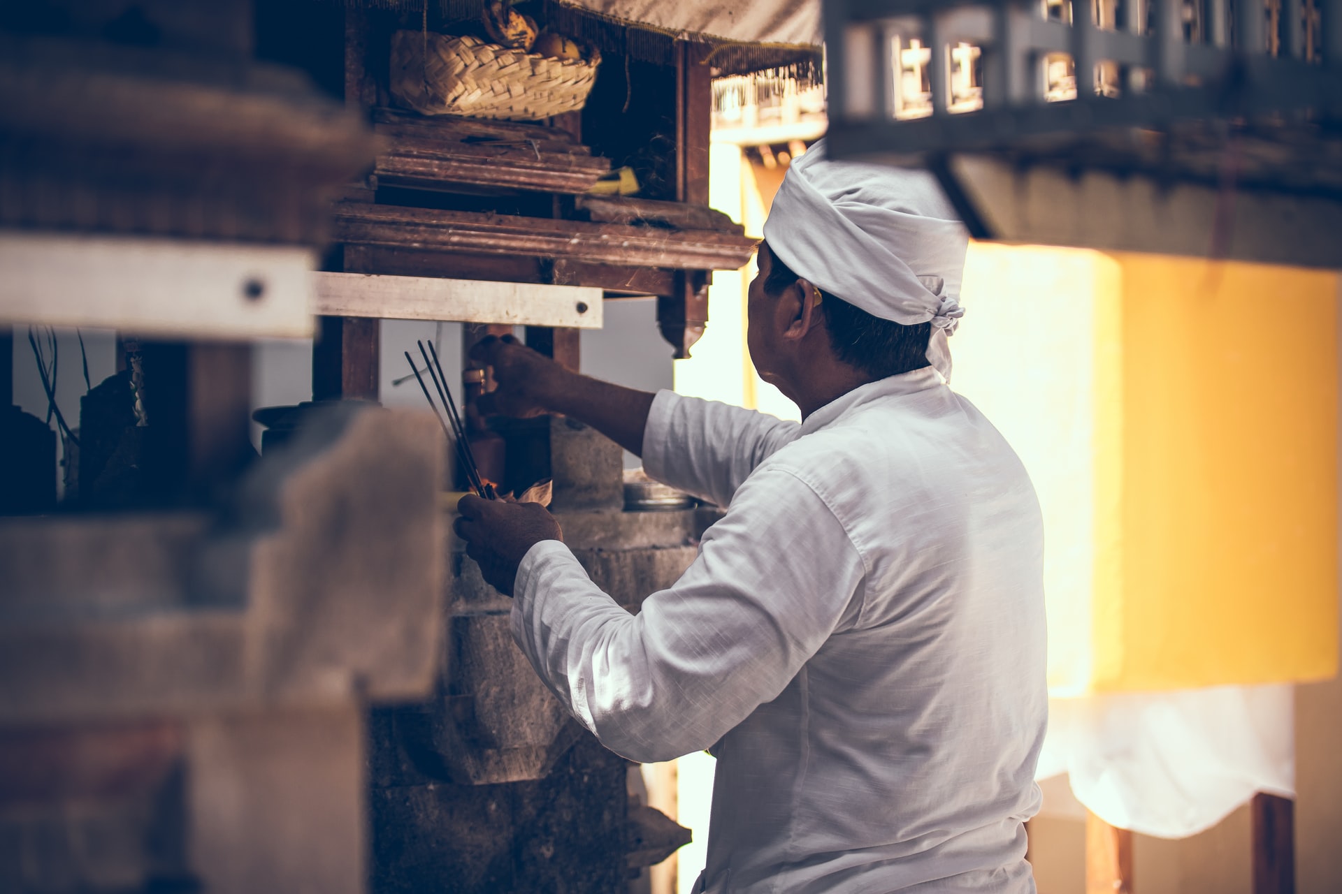 man wearing a chef outfit working in a restaurant