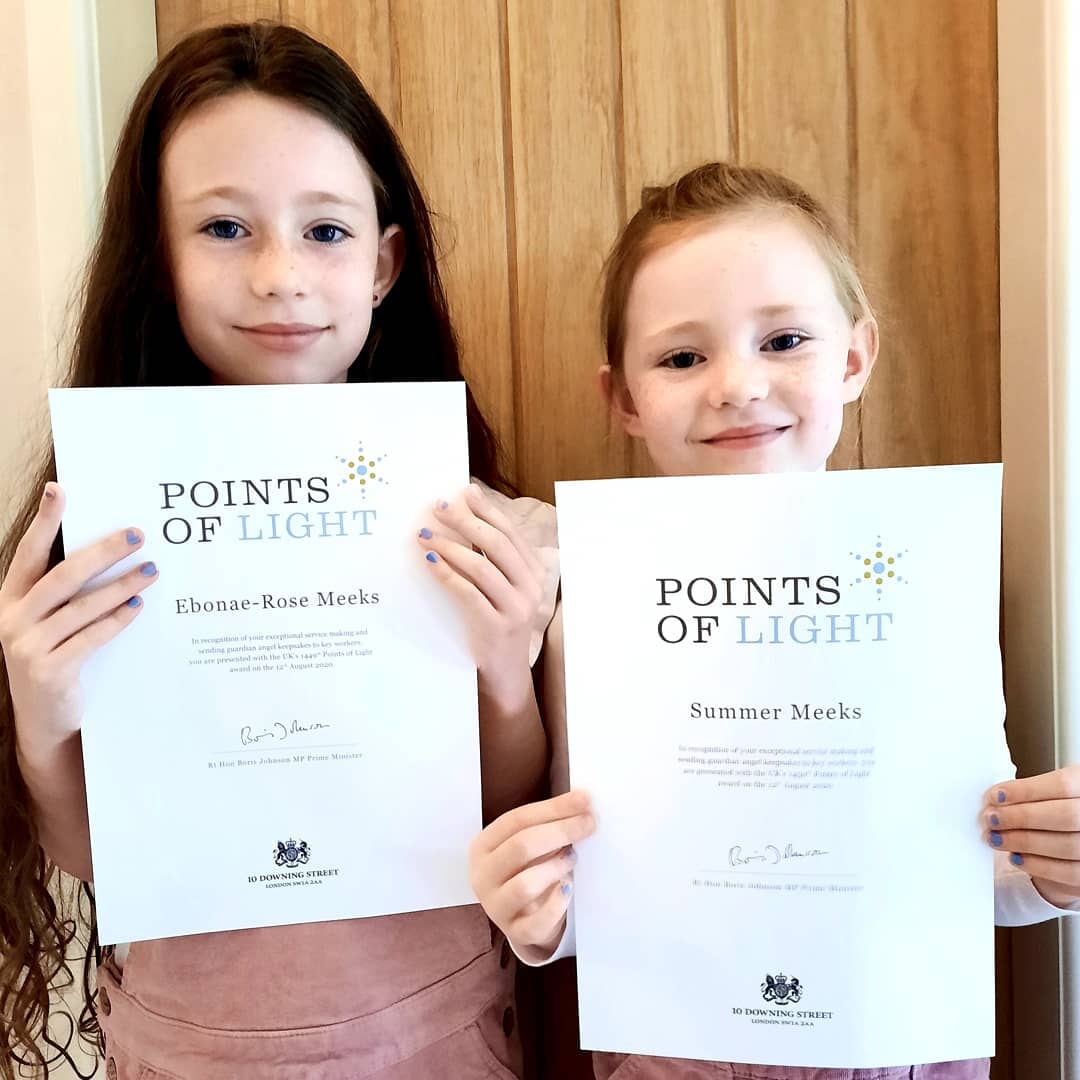 Sisters hold up their Point of Life certificates