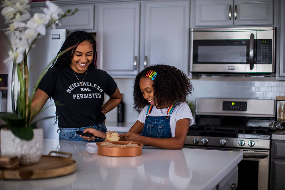 woman and girl at kitchen counter