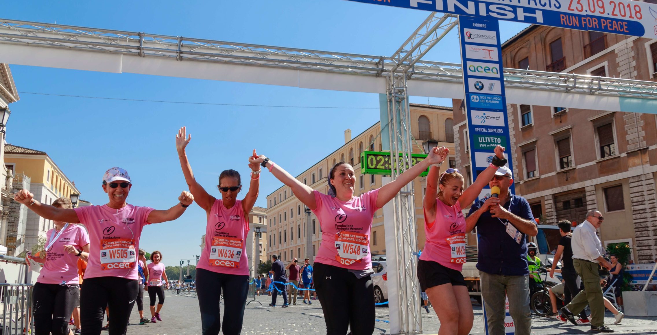 Group of women crossing finish line at a charity walk